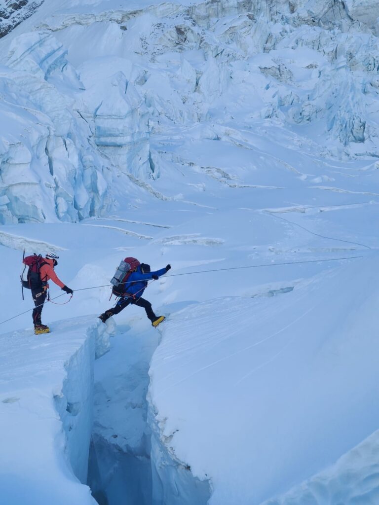 Dawa Sange Sherpa jumping over a crevasse in the Khumbu Ice Fall – his legs were the same length as Susan's. Credit Madison Mountaineering