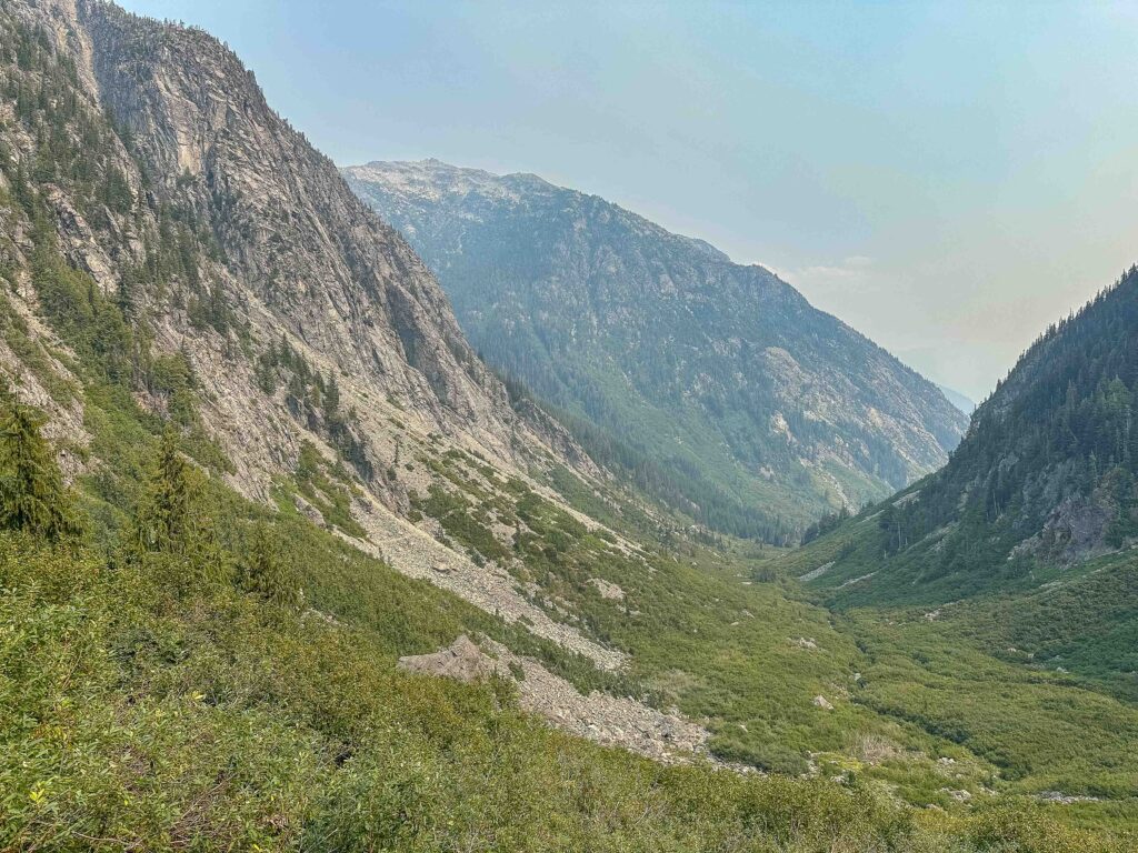 The steep terrain surrounding Basin Creek campground, in the shaded valley between the two cliffs.