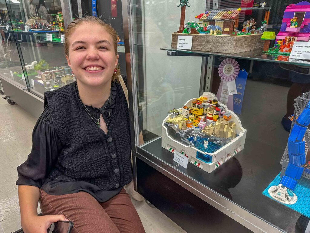 My daughter and her Reserve rosette for her organic Lego build in Structures of Italian city Cinque Terre.