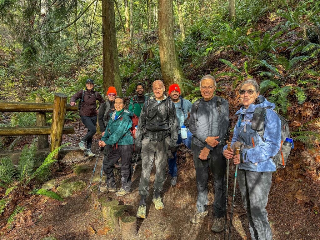 Happy hikers smile at the end of our lovely Whittaker Wilderness hike, complete with sunshine.