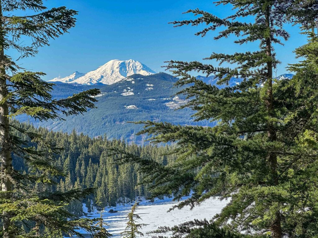 Mount Rainier looms above still-frozen Olallie Lake on April 24, 2026.