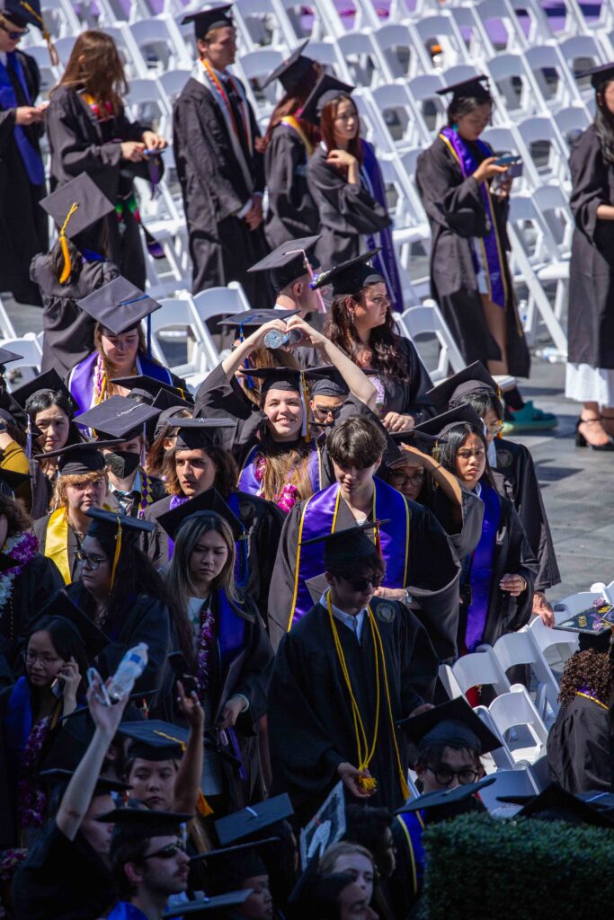 Our daughter sending us a heart as she lines up for the long wait to march across the stage.