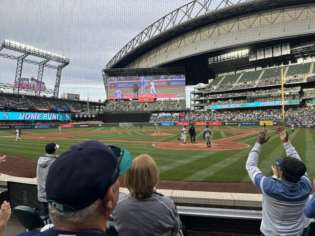 Celebrating a Mariners home run from fifth row seats behind home plate.
